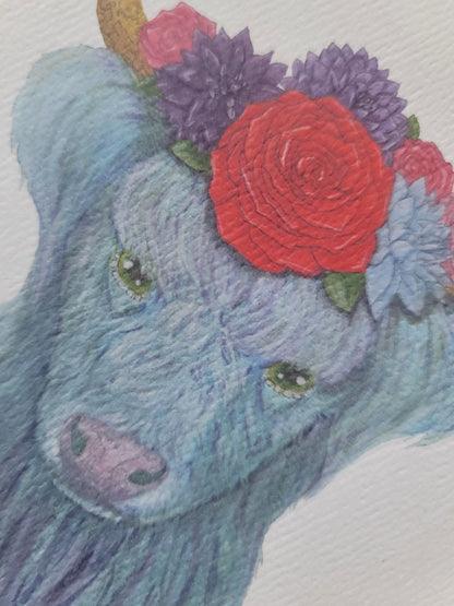 Watercolor illustration of a blue Highland cow with green eyes wearing purple and red flowers on its head.