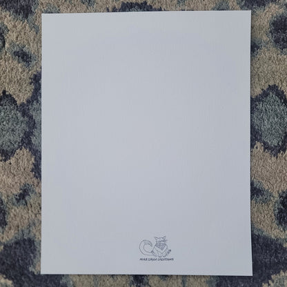 Blank white art print card with small gray logo at the bottom center on textured blue-gray surface.